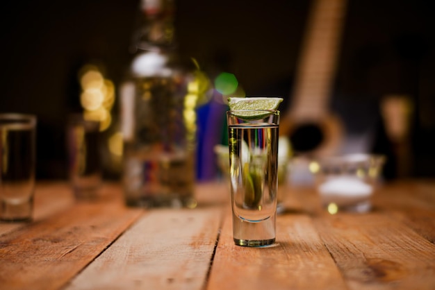 Shot of tequila on a wooden table