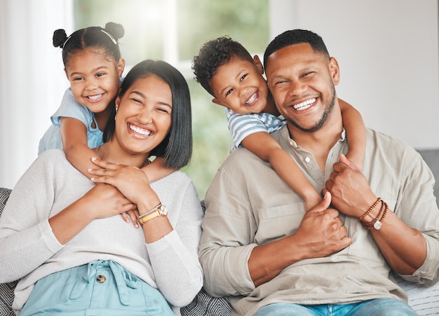 Shot of a young family happily bonding together on the sofa at home