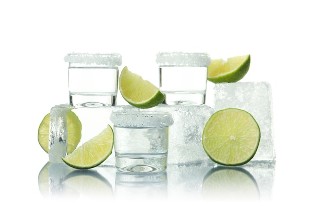 Shots ice and limes isolated on white background