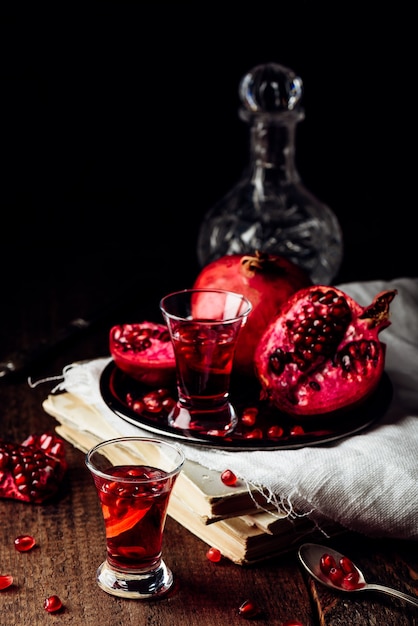 Shots of pomegranate cocktail with vodka and juice