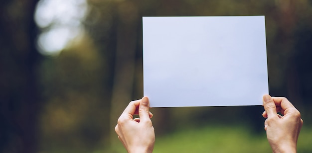 Show business paper in hand on nature