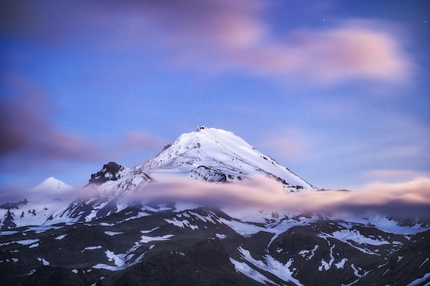 Show volcano view with blue sky and cloud background