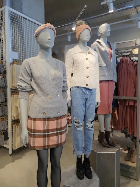 Showcase of woman clothes for fall winter on dummy