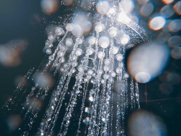 Shower head with flow of water spilling out closeup.