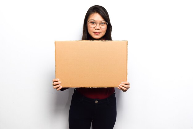 Showing blank sign poster for inscription and text of Young beautiful asian women dress red shirt