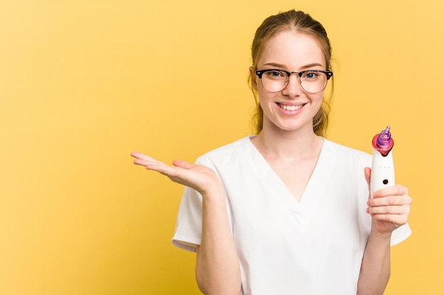 Showing a copy space on a palm and holding another hand on waist