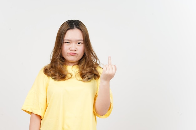 Showing fuck hand of Beautiful Asian Woman wearing yellow TShirt Isolated On White Background