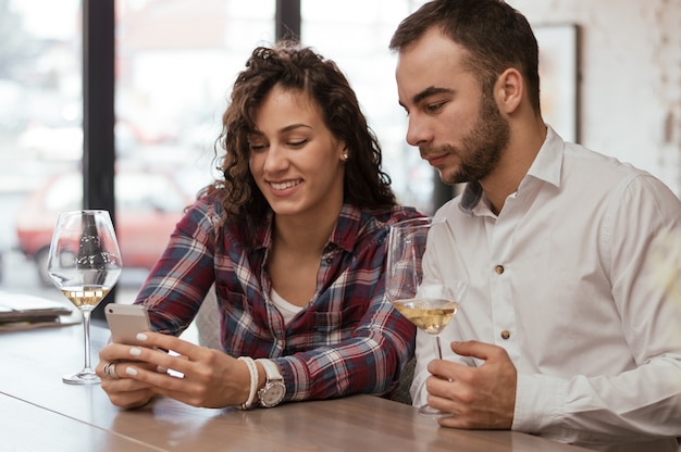 Showing him a picture of new dress while having a glass of wine