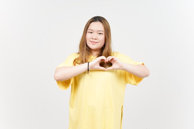 Showing Love Sign of Beautiful Asian Woman wearing yellow TShirt Isolated On White Background