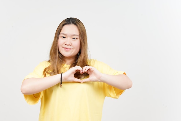 Showing Love Sign of Beautiful Asian Woman wearing yellow TShirt Isolated On White Background