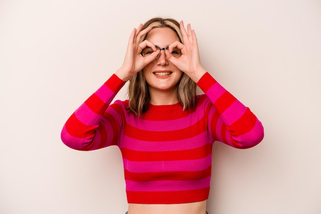 Showing okay sign over eyes