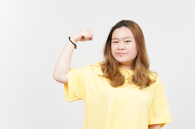 Showing Strength Arms of Beautiful Asian Woman wearing yellow TShirt Isolated On White Background