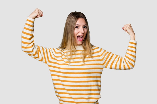 Showing strength gesture with arms symbol of feminine power