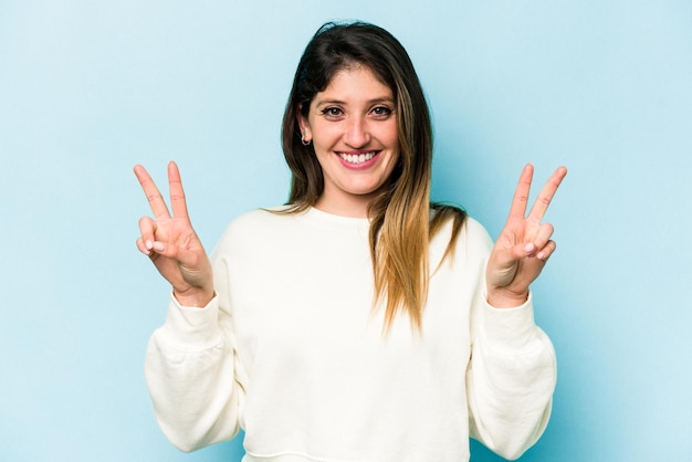 Showing victory sign and smiling broadly