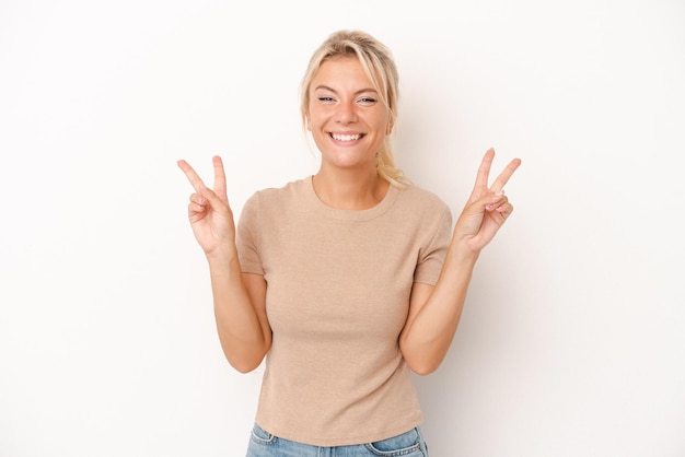 Showing victory sign and smiling broadly