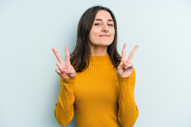 Showing victory sign and smiling broadly