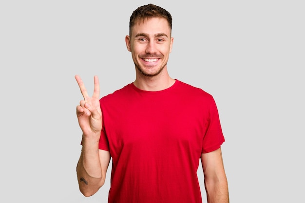 Showing victory sign and smiling broadly