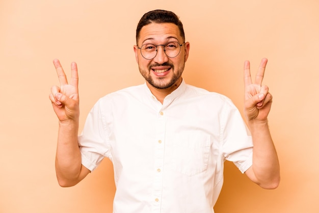 Showing victory sign and smiling broadly