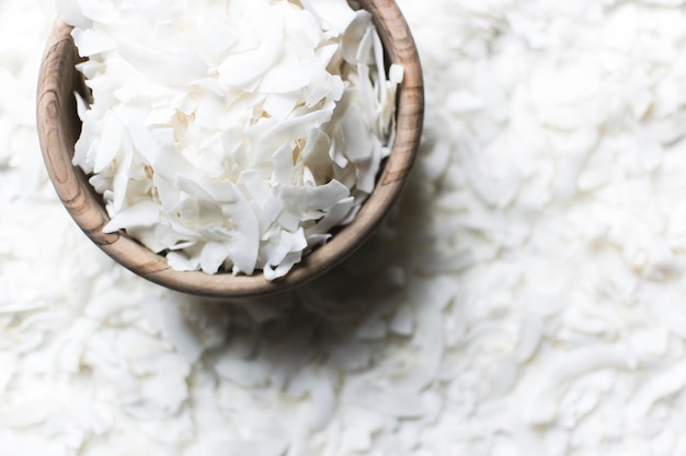 Shredded coconut in wooden bowl