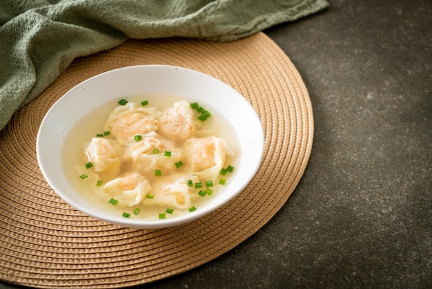 shrimp dumpling soup in white bowl - Asian food style