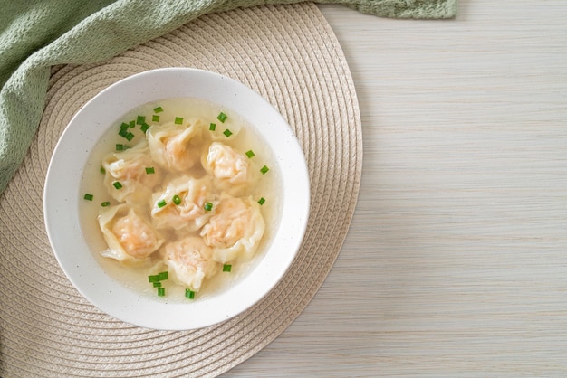 shrimp dumpling soup in white bowl - Asian food style