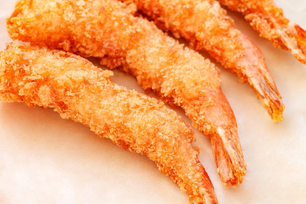 Shrimp fried in batter on craft paper selective focus