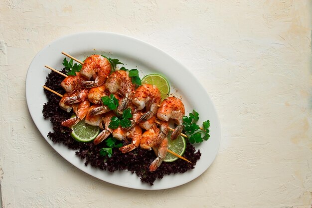 Shrimp kebab with spices lime on wooden skewers top view no people