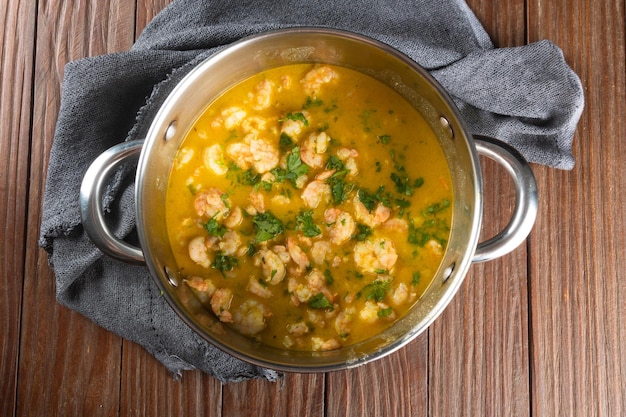 Shrimp moqueca in aluminum pan top view Brazilian traditional food