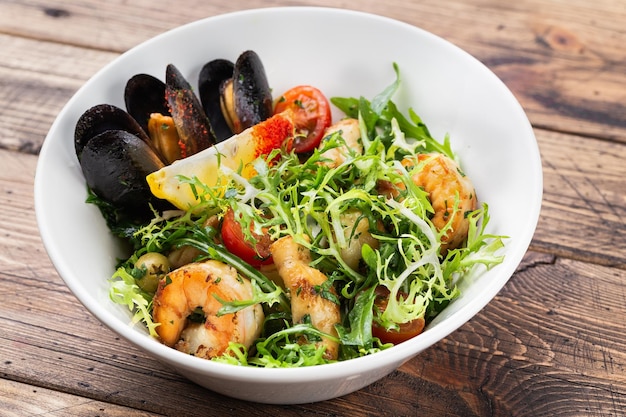 Shrimp and mussels Salad Fresh Seafood Salad on wooden background top view copy space