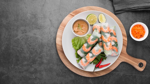 Shrimp rolls with sauce on plate with copy space