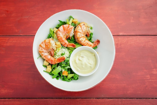 Shrimp Salad Healthy Seafood Caesar Salad with prawns on the wooden tabletop view