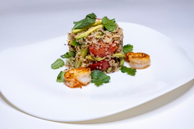 Shrimp salad on a white plate shrimps tomatoes restaurant menu home cooking cous cous copy space