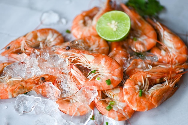 Shrimp on seafood plate and wooden background dining table food Fresh shrimps prawns lemon lime with herbs and spice