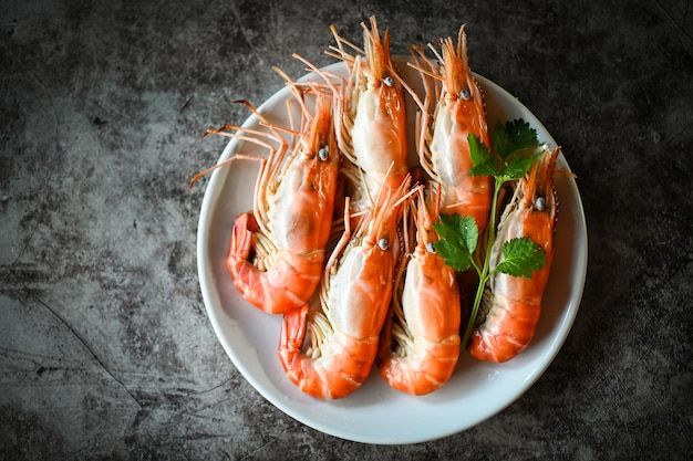 Shrimp on white plate dining table food Fresh shrimps prawns seafood with herbs and spice boiled shrimp