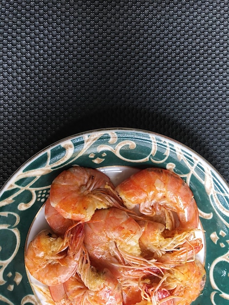 Shrimps in plate on a grey concrete background