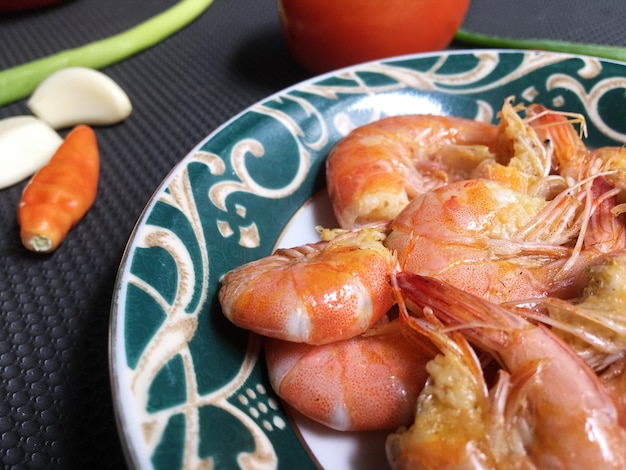 Shrimps in plate on a grey concrete background