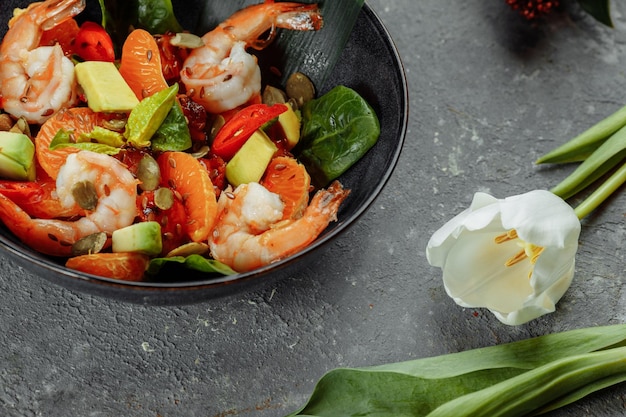 Shrimps salad with cherry tomatoes cucumeber avocado lettuce and pomegranate on dish healthy seafood