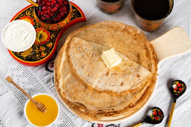 Shrovetide Maslenitsa festival Russian pancakes blini Pancakes with honey and jam Russian spoons National russian festival Russian crepes