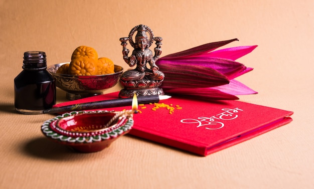 shubha labh written on red accounting note book or bahi khata for laxmi pujan in diwali