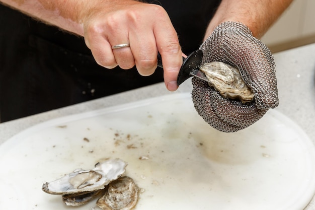 Shucking fresh oysters with a knife