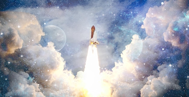 Shuttle launch in the clouds to outer space Dark space with stars on backgroundSpaceship flight Elements of this image furnished by NASA