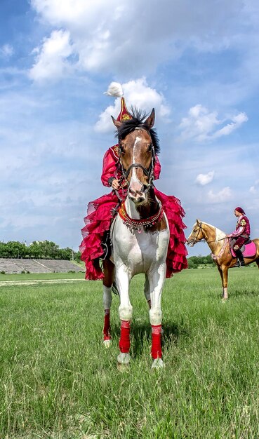 Shymkent Kazakhstan May 16 2018 A holiday at the city hippodrome in honor of the beginning of the Holy month of Ramadan Girls in national costumes on horseback