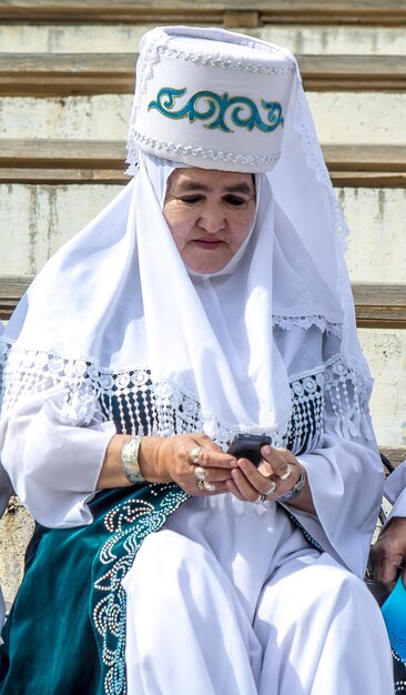 Shymkent Kazakhstan May 16 2018 A holiday at the city hippodrome in honor of the beginning of the Holy month of Ramadan Old women in white national clothes on the podium