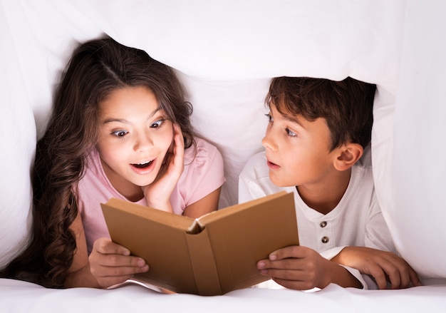 Siblings bed time reading stories