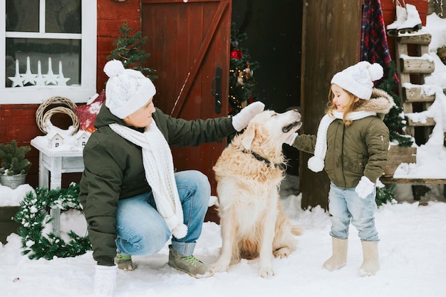 siblings girl sister and teenage cute boy brother in knitted sweater and hat having fun