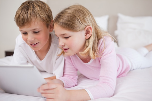 Siblings using a tablet computer