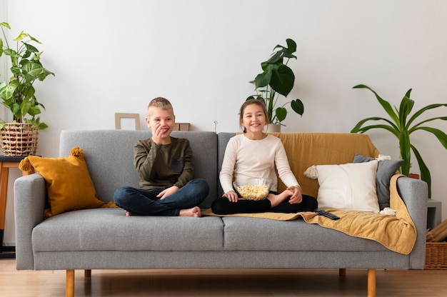 Siblings watching television together