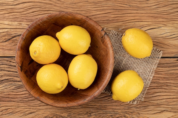 Sicilian lemons in a bowl over wooden table