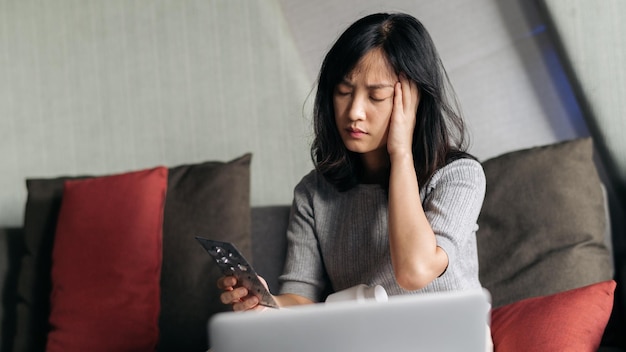 Sick asian woman with medicine having video call conference medical app in telehealth on laptop Healthcare technology and people concept