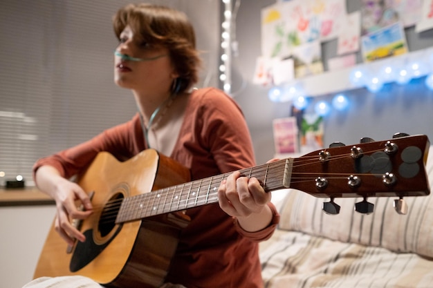 Sick girl playing guitar at hospital ward